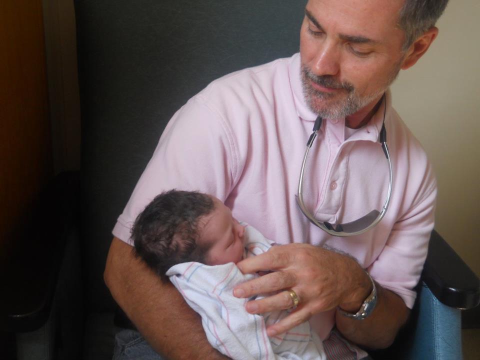 Derek Logan with his newborn granddaughter Derek Logan with his newborn granddaughter